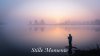 Man fishing at a calm lake at sunrise mist over th_4.jpg